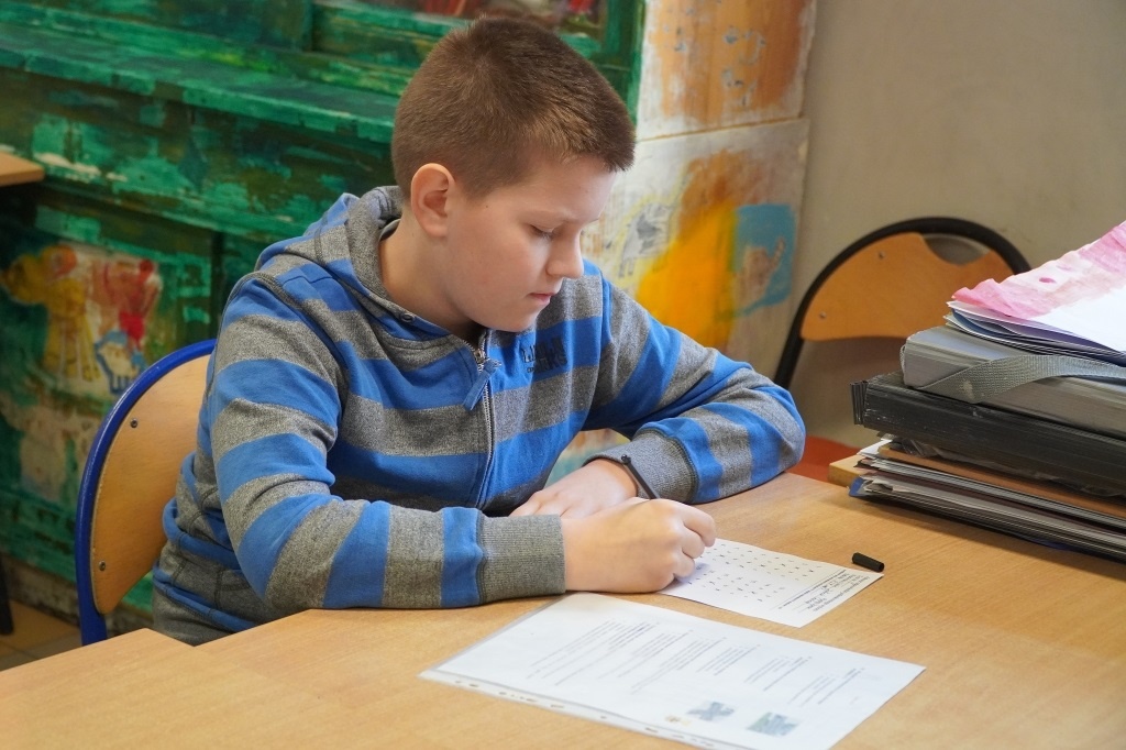 Uczeń z PSP 3 Kozienice piszący test z przepisów ruchu drogowego podczas XXVII Powiatowego Turnieju Wiedzy o BRD "Jesienny rower"